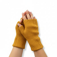  knitted fingerless gloves worn on a white background