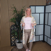 Woman standing in a room with decorative elements and plants