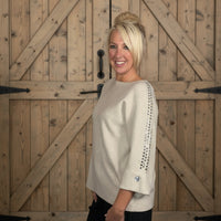 beige sweater with heart jewels