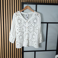 Darcy crochet buttoned jacket white hanging up on wall