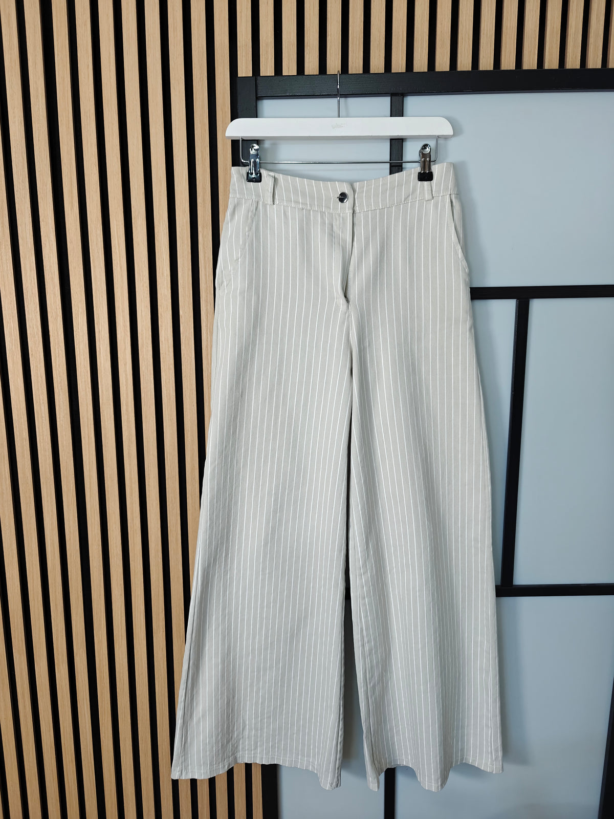 Beige jeans hanging up 
