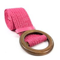 Pink belt with a wooden ring buckle on a white background