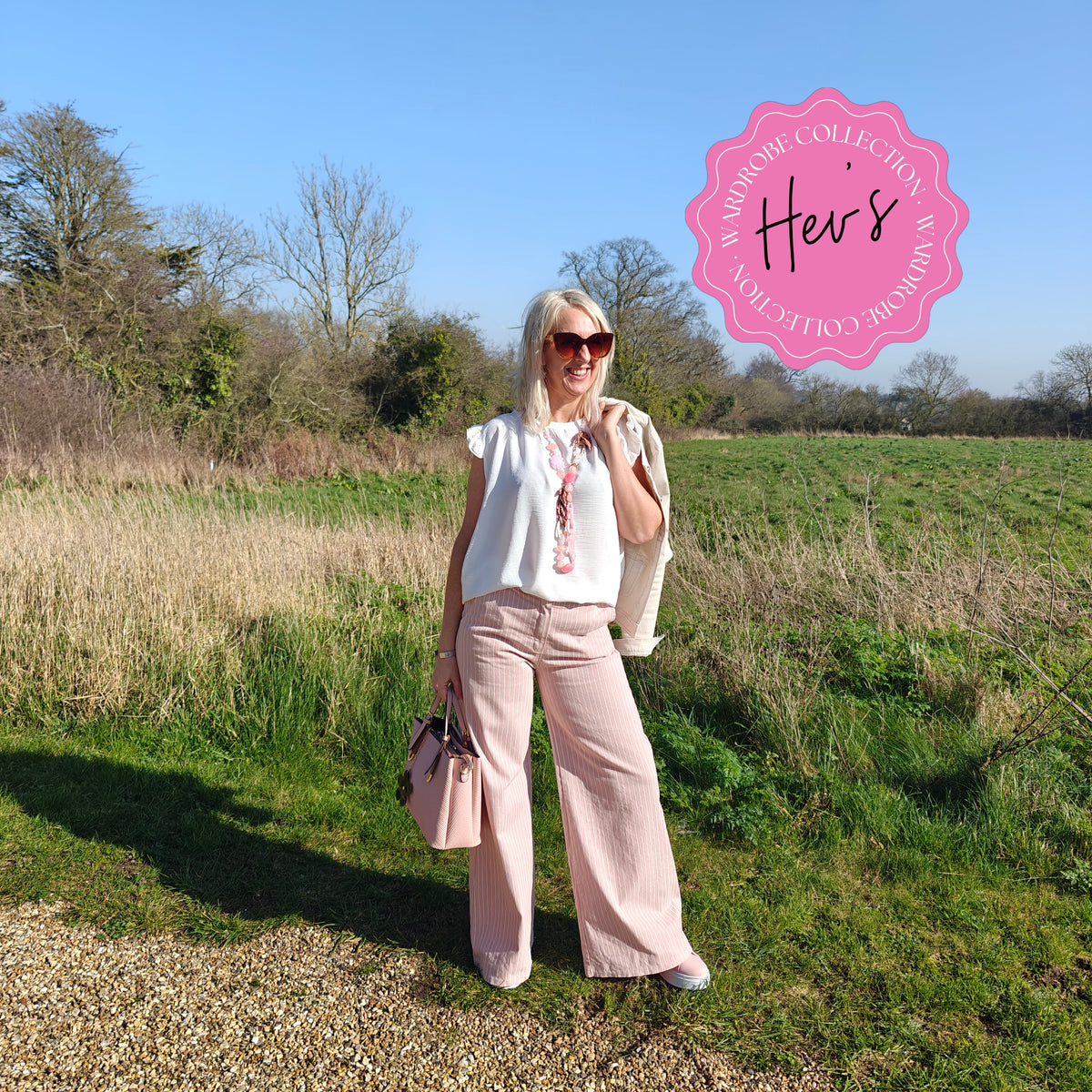 Woman standing in a field with a 'Her's' logo in the corner