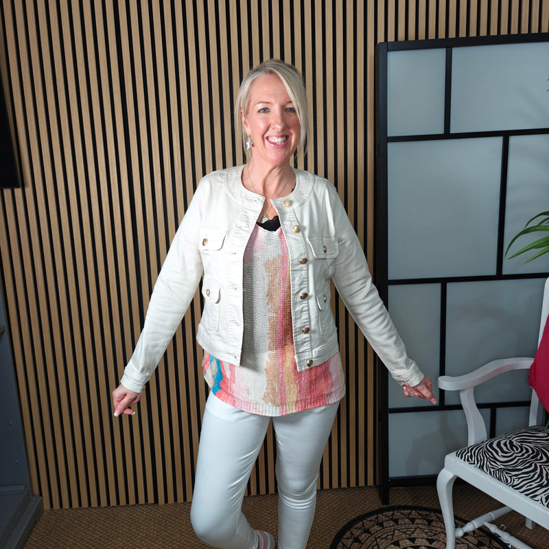 Denim jacket worn with cotton top styled with trainers 