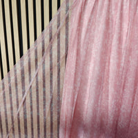 Close-up of pink and brown striped fabric with a blurred background