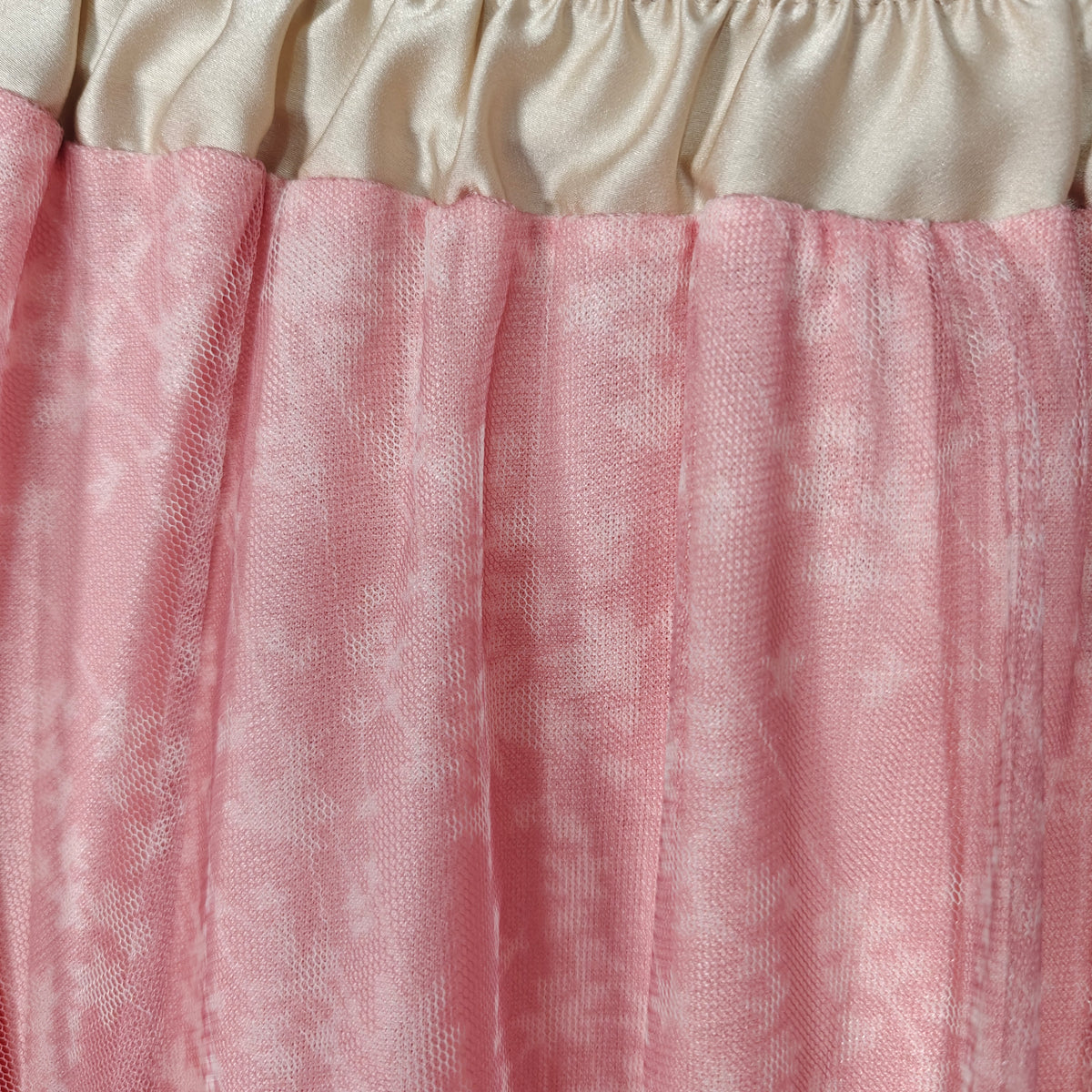 Close-up of a pink and beige fabric texture