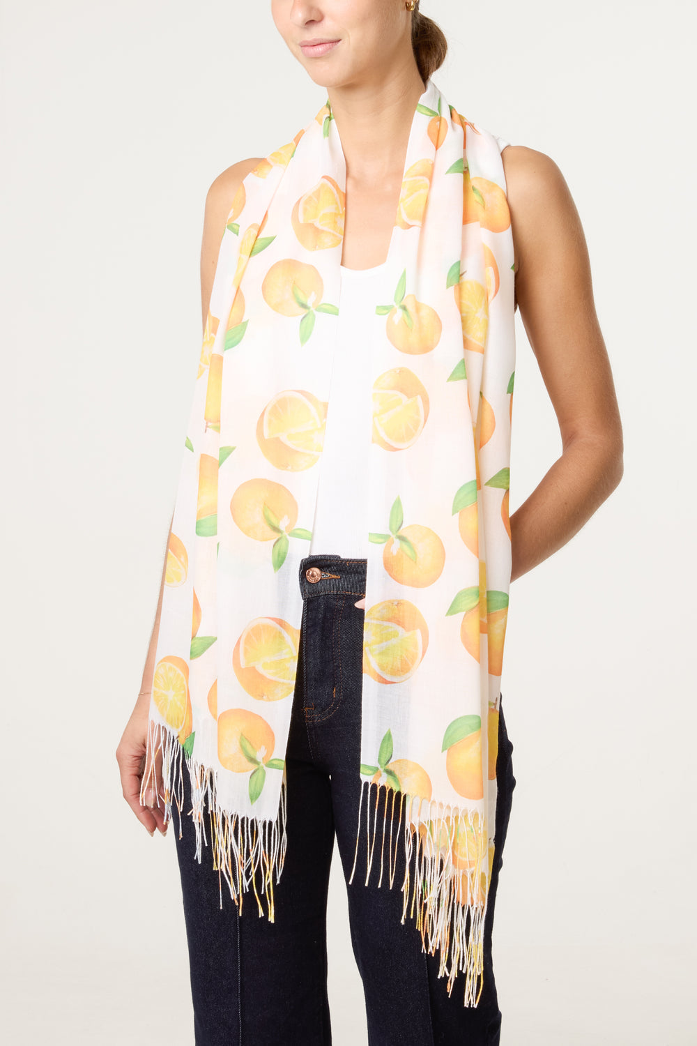 Woman wearing a scarf with peach pattern on a plain background