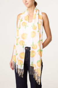 Woman wearing a scarf with peach pattern on a plain background