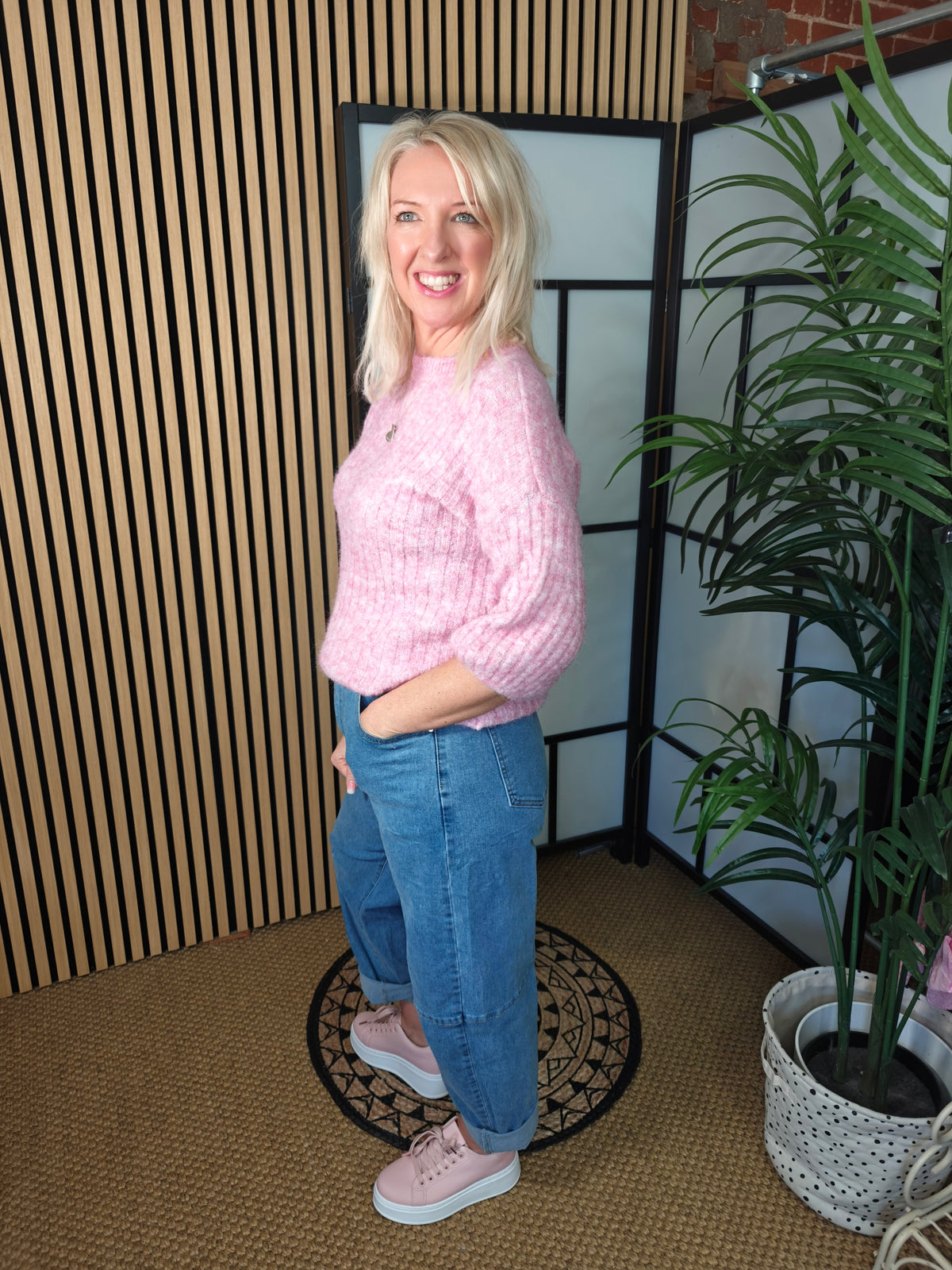 Side profile of lady styling jeans and jumper

