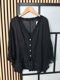 Black lace top on hanger 