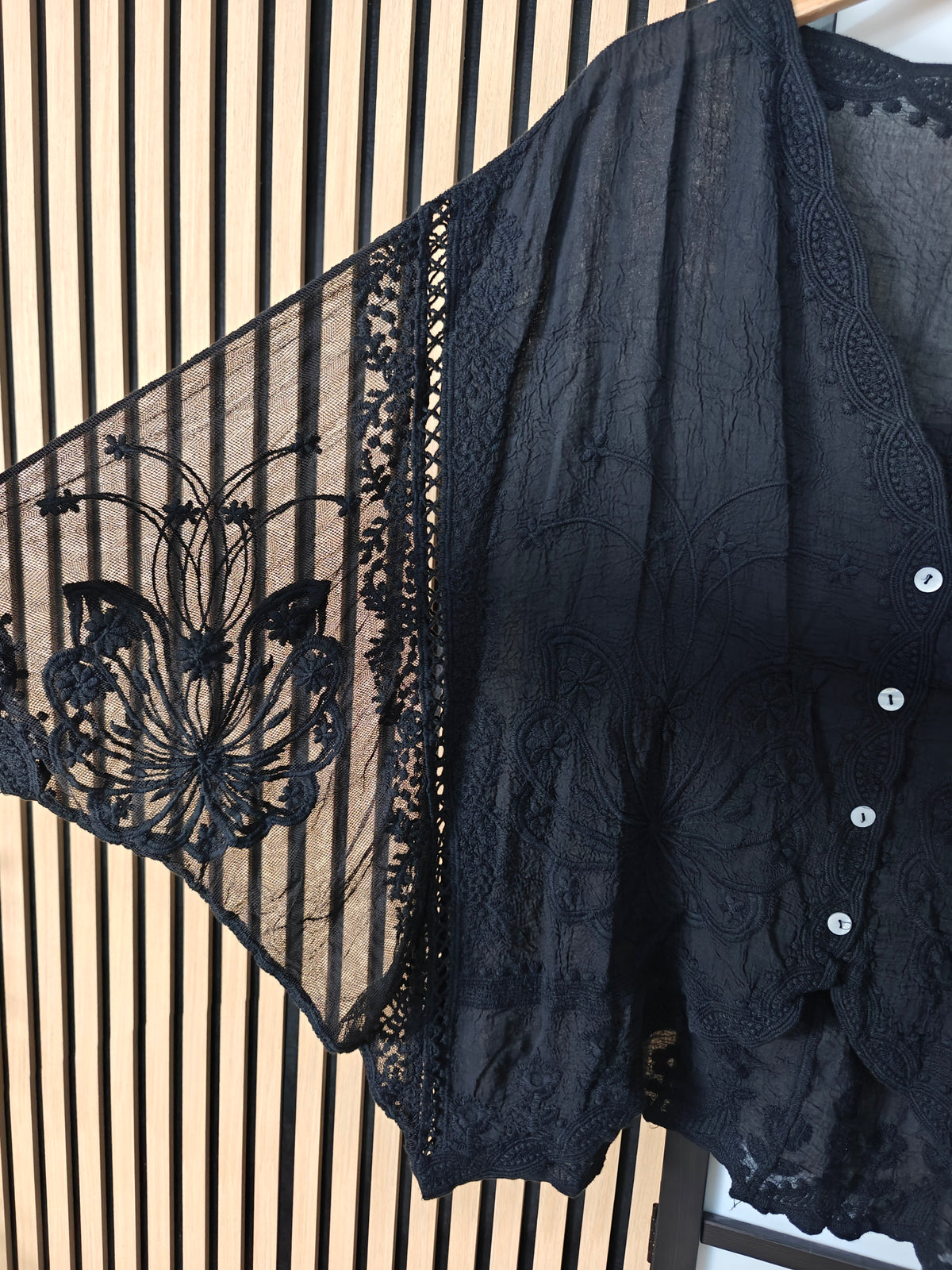 Close up image of black lace top dkeey