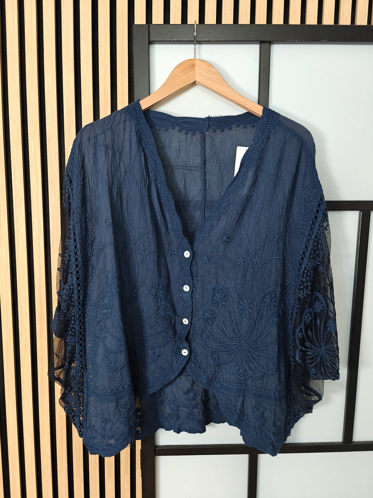 Navy lace top on hanger 