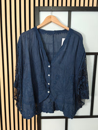 Navy lace top on hanger 