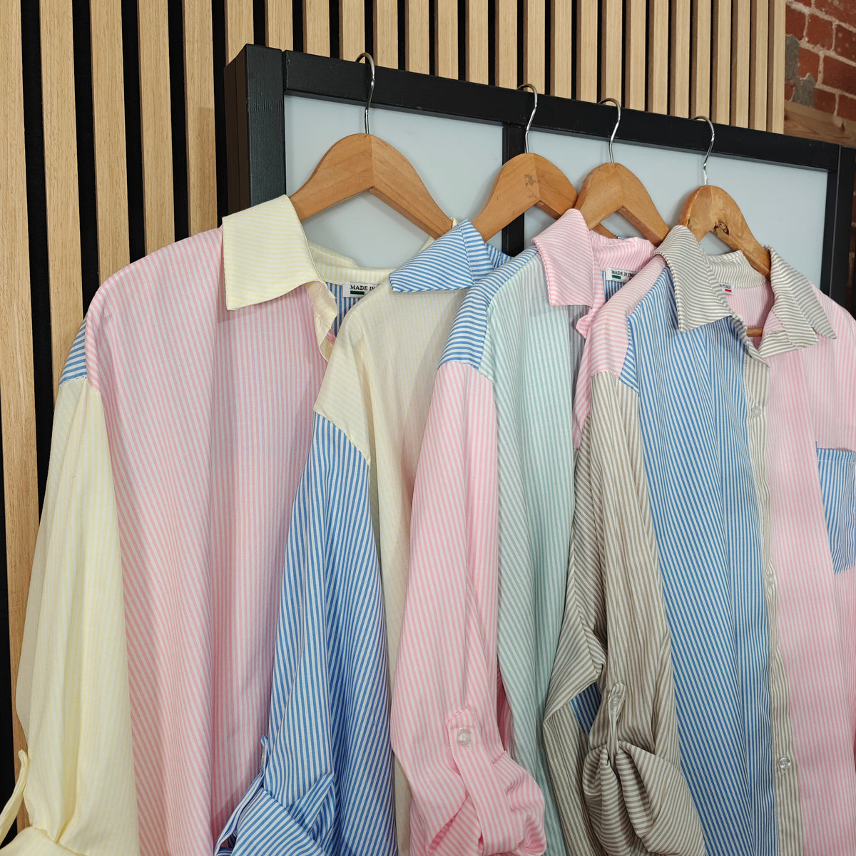 Striped colourful blouses hanging 