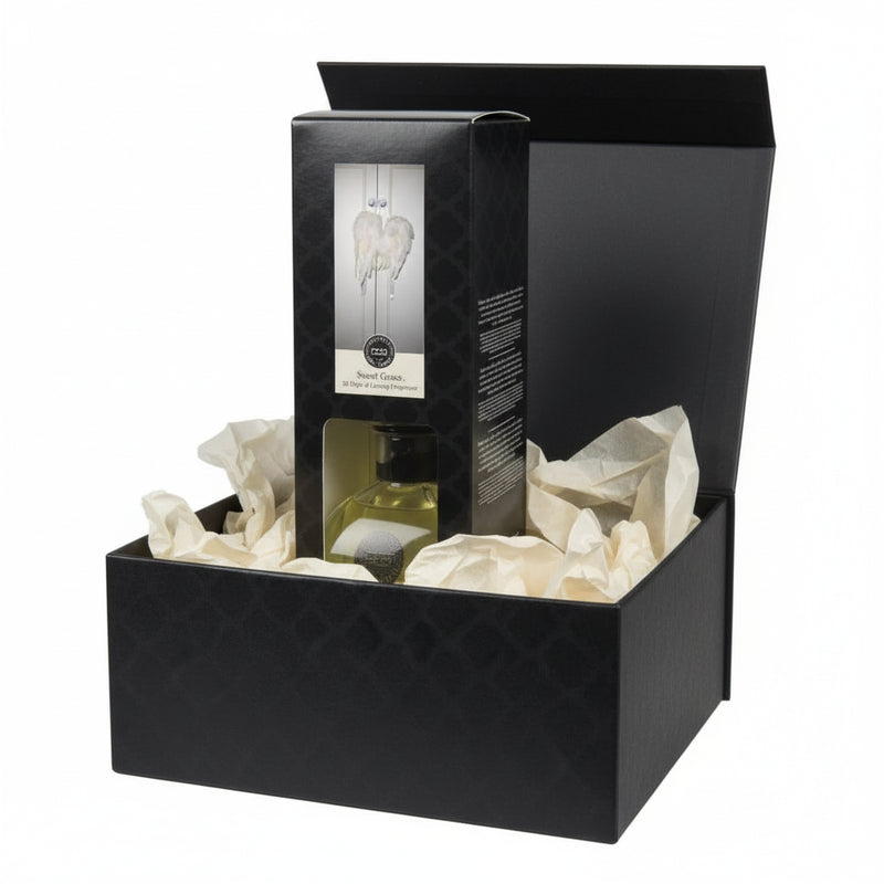 Reed diffuser packaging with clear window showing product inside on a white background