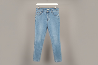 Light blue jeans on a hanger against a gray background