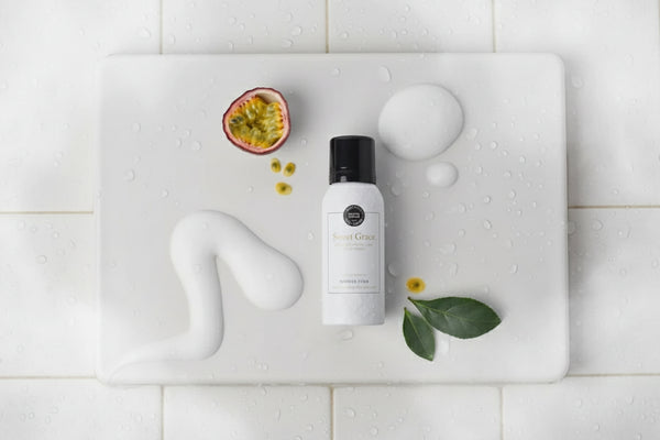 White bottle with black cap on a light gray background with decorative elements