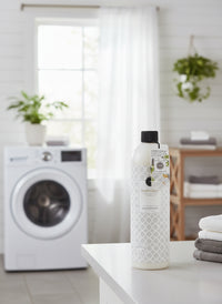 Bottle of Sweet Grace laundry detergent on a white background