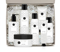 Set of white skincare products with black caps on a white background