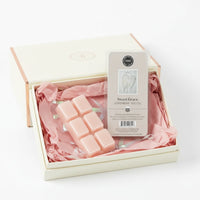 Set of pink wax melts with a 'Sweet Grace' packaging on a white background