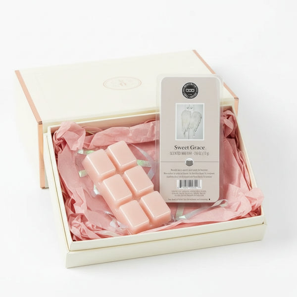 Set of pink wax melts with a 'Sweet Grace' packaging on a white background